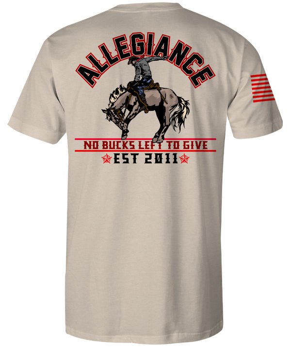 Back of Bucked Premium Tee in natural color showcasing large cowboy riding a bucking horse graphic with "No Bucks Left to Give" slogan and Allegiance text.
